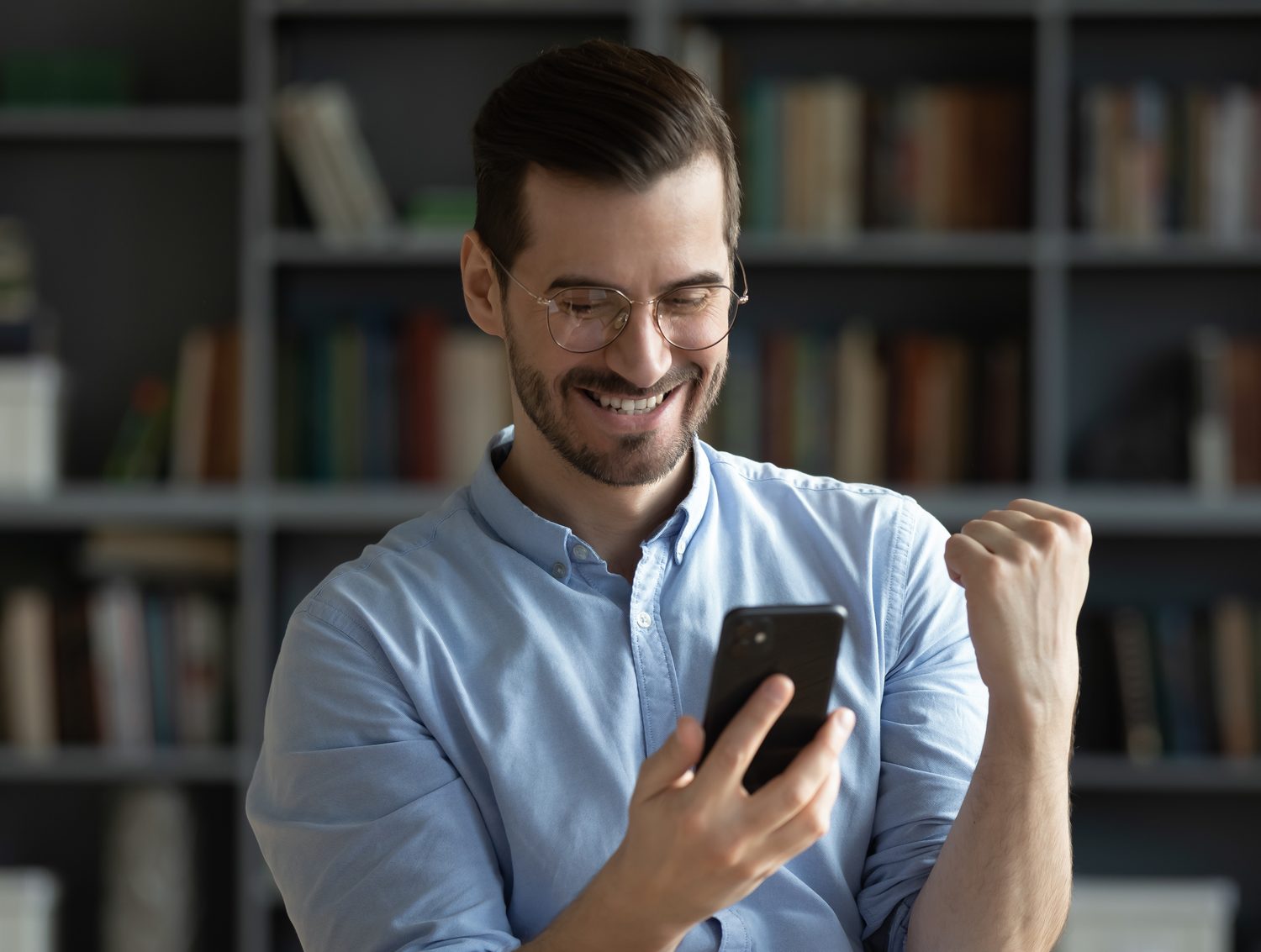 A man reading his result on his phone at home